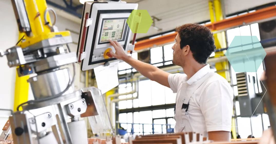 A man working on a machine in an industrial facility