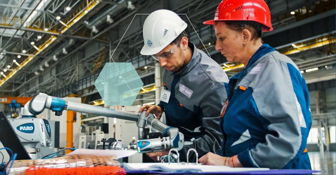 Two employees working with a machine in a plant