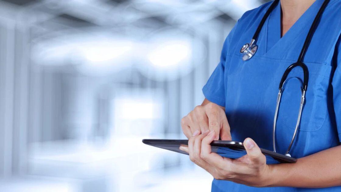 A doctor checking her tablet