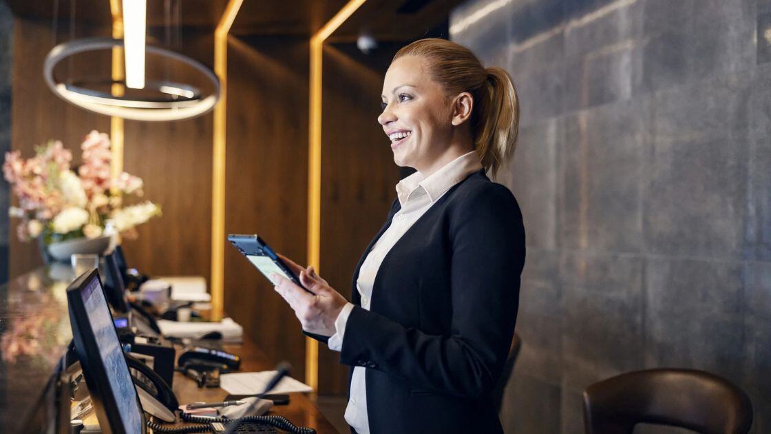 Hospitality employee working the front desk at a hotel