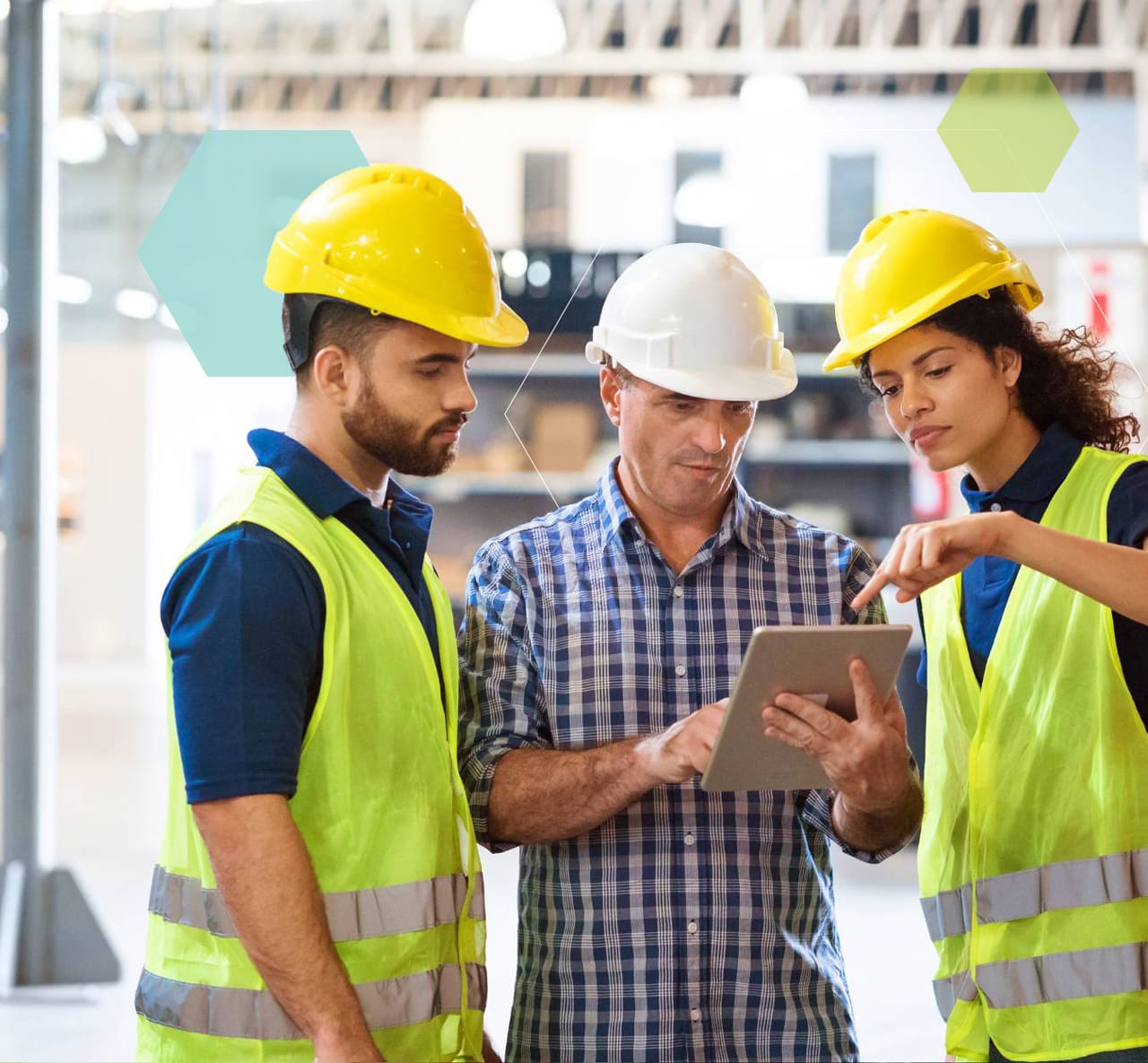 People in a manufacturing plant working on a tablet