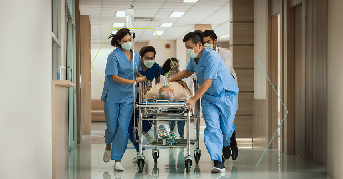 Hospital staff moving a person down a hallway