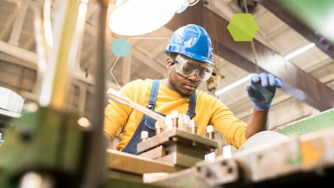 Manufacturing employee looking over equipment